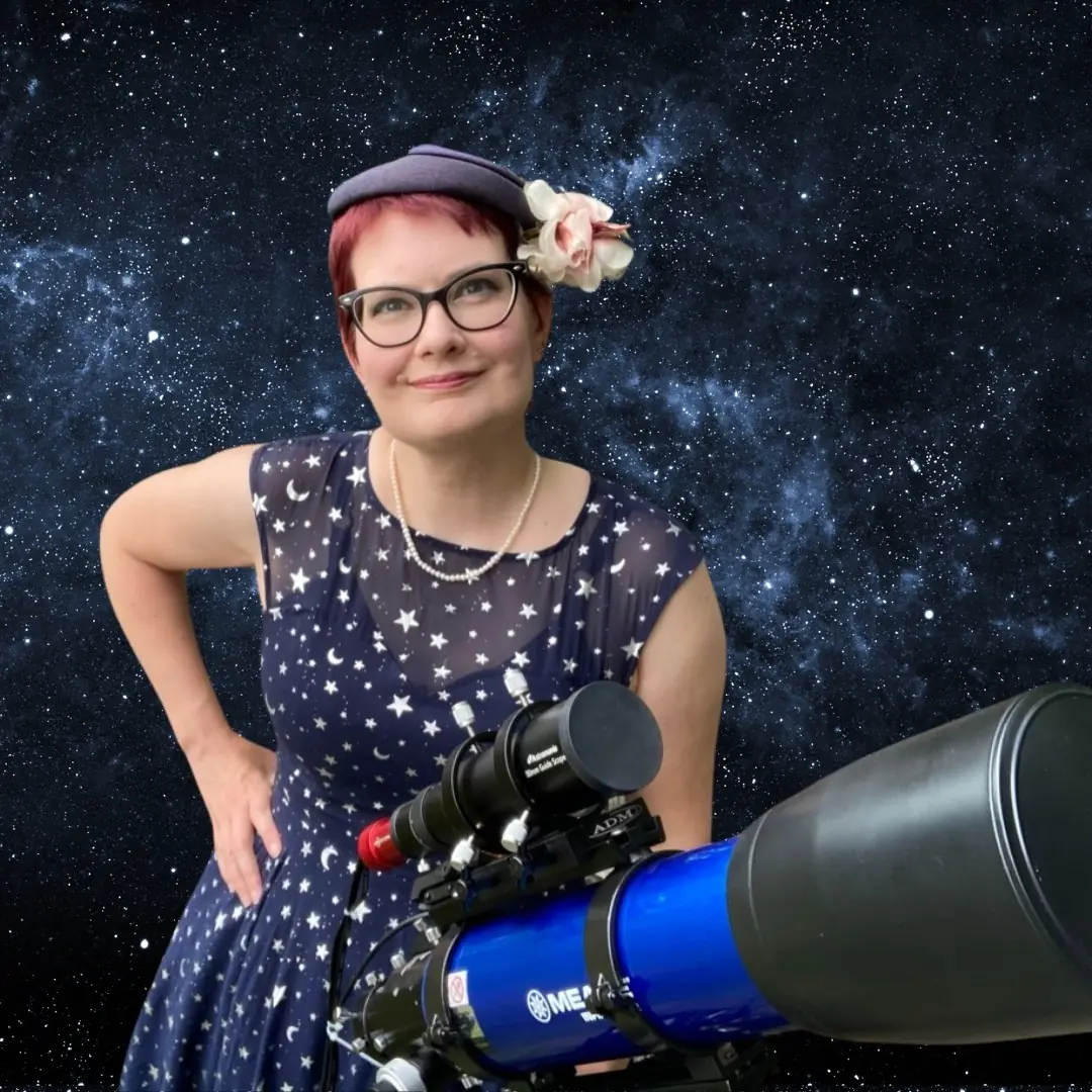 Woman in star-pattern dress and beret posing with telescope against galaxy backdrop